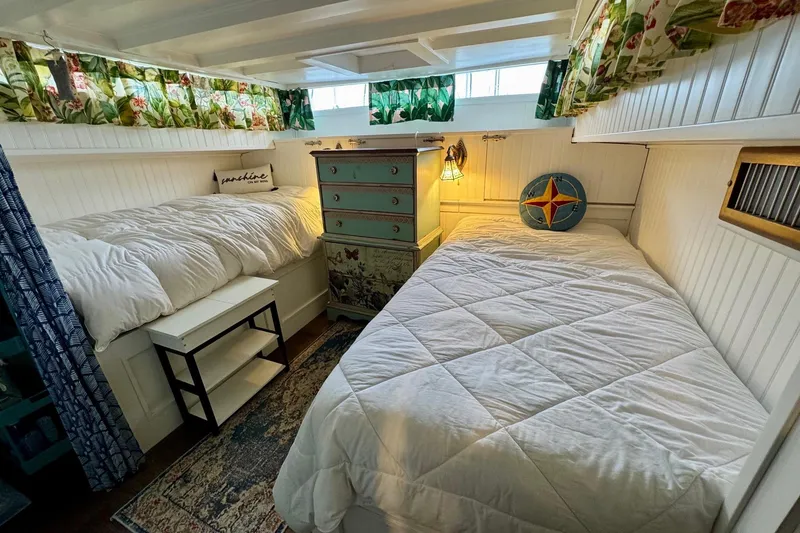Slide: The Image of Cozy cabin interior of 1970 Chris-Craft Commander 42 with twin beds and nautical decor. - 44