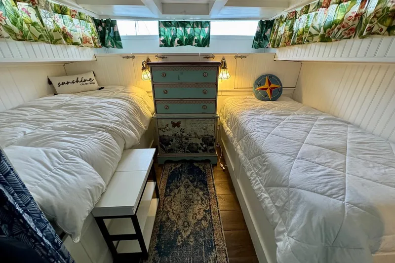 Slide: The Image of Cozy cabin interior of 1970 Chris-Craft Commander 42 with twin beds and nautical decor. - 45
