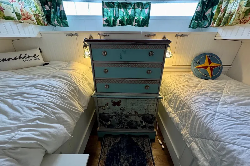Slide: The Image of 1970 Chris-Craft Commander 42 cabin with twin beds, vintage decor, and nautical accents. - 46