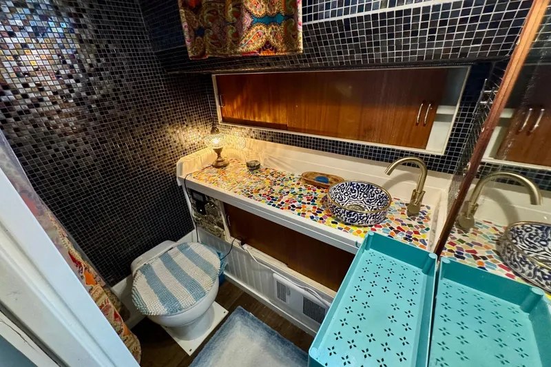 Slide: The Image of Vintage 1970 Chris-Craft Commander 42 bathroom with mosaic countertop and patterned sink. - 48