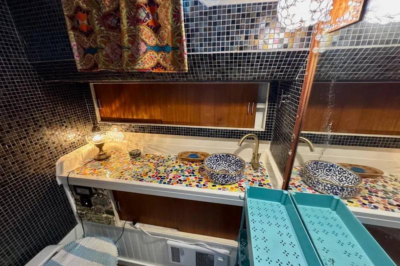 Slide: The Image of Vintage 1970 Chris-Craft Commander 42 bathroom with mosaic countertop and decorative sink. - 49