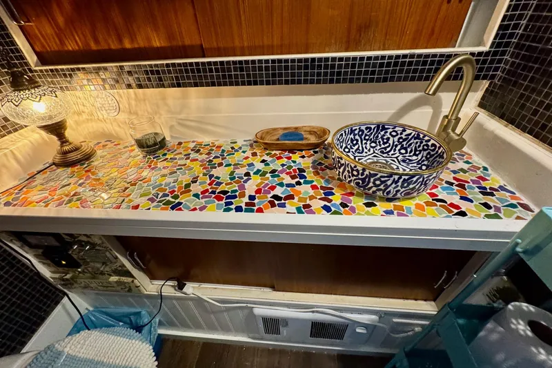 Slide: The Image of Colorful mosaic countertop with decorative sink in 1970 Chris-Craft Commander 42 boat. - 50