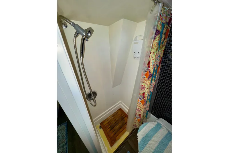 Slide: The Image of Shower area in 1970 Chris-Craft Commander 42 with colorful curtain and wooden floor mat. - 52