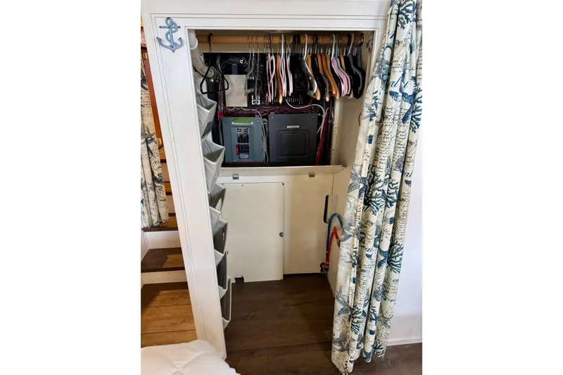 Slide: The Image of 1970 Chris-Craft Commander 42 closet with electrical panel and hanging clothes. - 54
