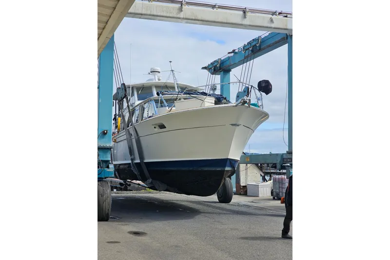 Slide: The Image of 1970 Chris-Craft Commander 42 yacht being lifted at a marina. - 6