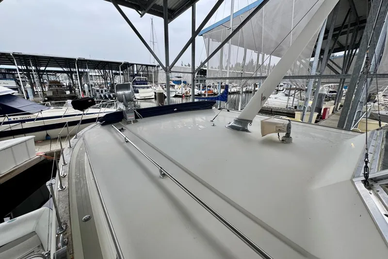 Slide: The Image of 1970 Chris-Craft Commander 42 docked in a marina under a covered structure. - 61