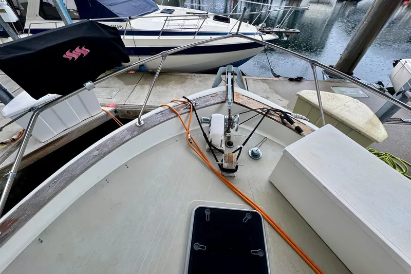 Slide: The Image of 1970 Chris-Craft Commander 42 docked, showcasing bow details and marina setting. - 62