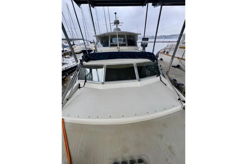 Slide: The Image of 1970 Chris-Craft Commander 42 docked, showcasing classic design and spacious deck. - 63