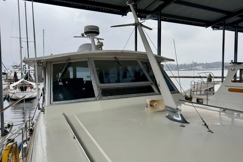 Slide: The Image of 1970 Chris-Craft Commander 42 docked under a covered marina, showcasing its classic design. - 64