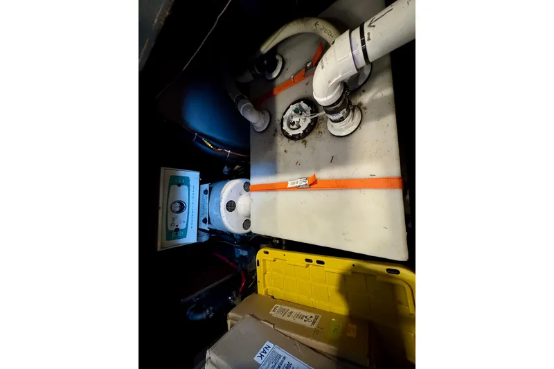 Slide: The Image of Engine room of 1970 Chris-Craft Commander 42 with visible plumbing and equipment. - 69