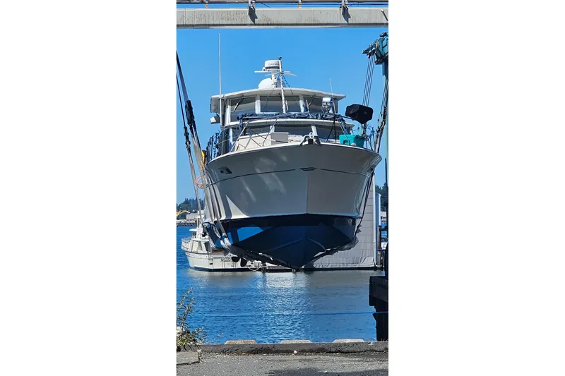 Slide: The Image of 1970 Chris-Craft Commander 42 yacht suspended over water at a marina. - 7