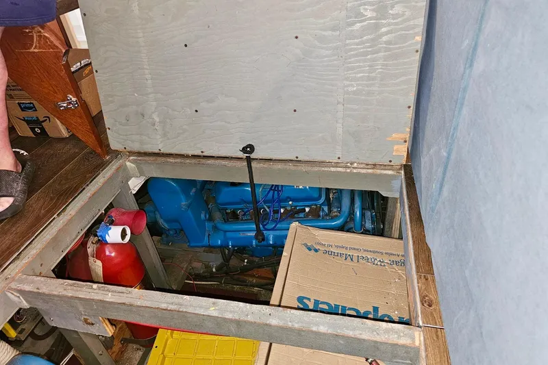 Slide: The Image of 1970 Chris-Craft Commander 42 engine compartment with visible blue engine and fire extinguisher. - 71