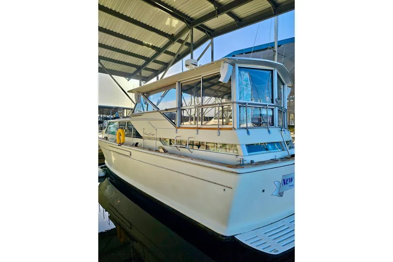 Slide: The Image of 1970 Chris-Craft Commander 42 yacht docked under a covered marina. - 74