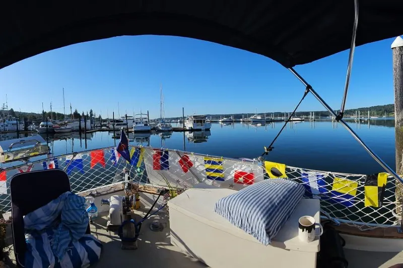 Slide: The Image of 1970 Chris-Craft Commander 42 at marina with colorful flags and calm water. - 76