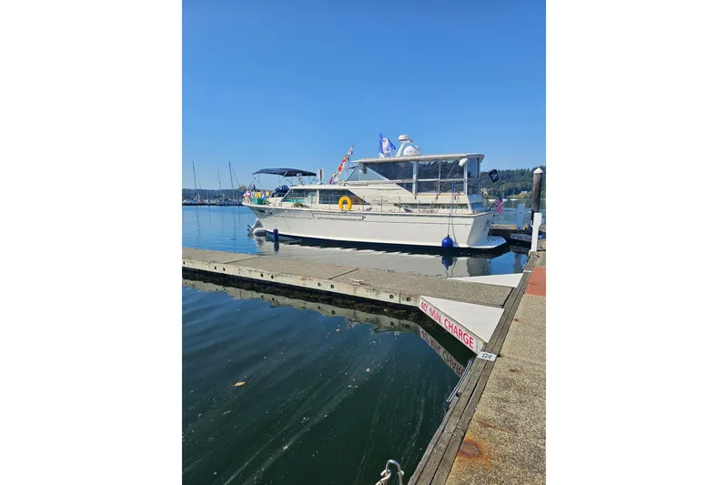 Slide: The Image of 1970 Chris-Craft Commander 42 yacht docked at a marina on a sunny day. - 8