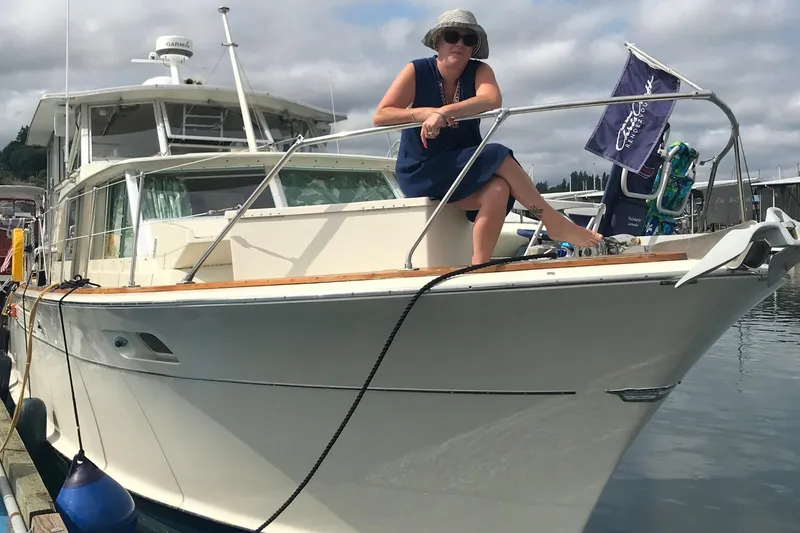 Slide: The Image of Woman sitting on 1970 Chris-Craft Commander 42 yacht docked at marina. - 80