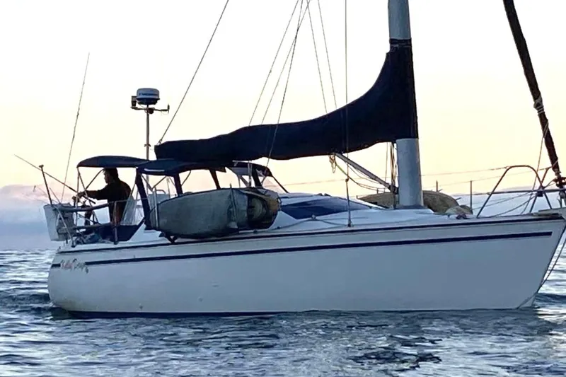 The Image of 1989 Hunter Vision 32 sailboat on calm water at sunset. - 0
