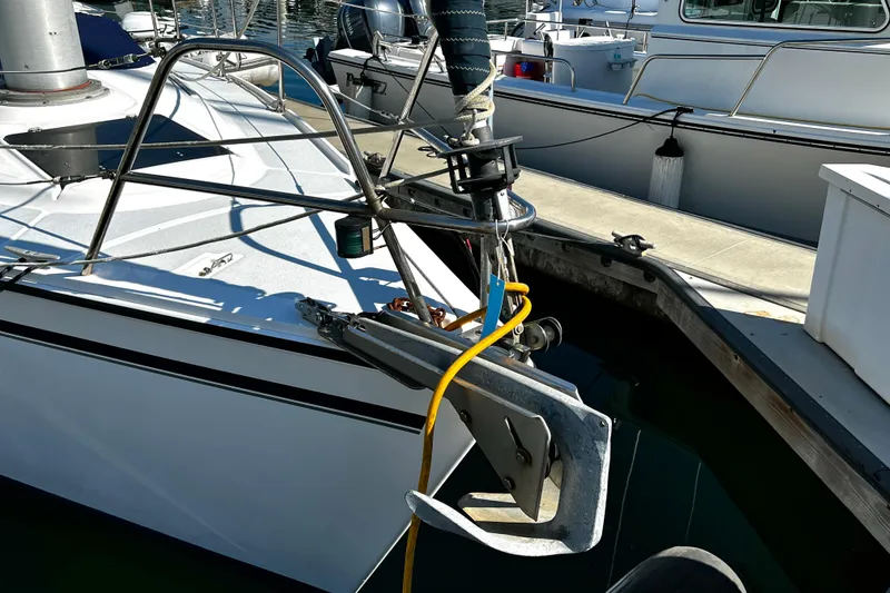 Slide: The Image of 1989 Hunter Vision 32 sailboat docked, featuring anchor and deck details. - 12