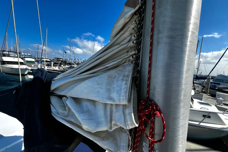 Slide: The Image of Sailboat mast with furled sail, Hunter Vision 32, 1989, docked in marina under blue sky. - 19