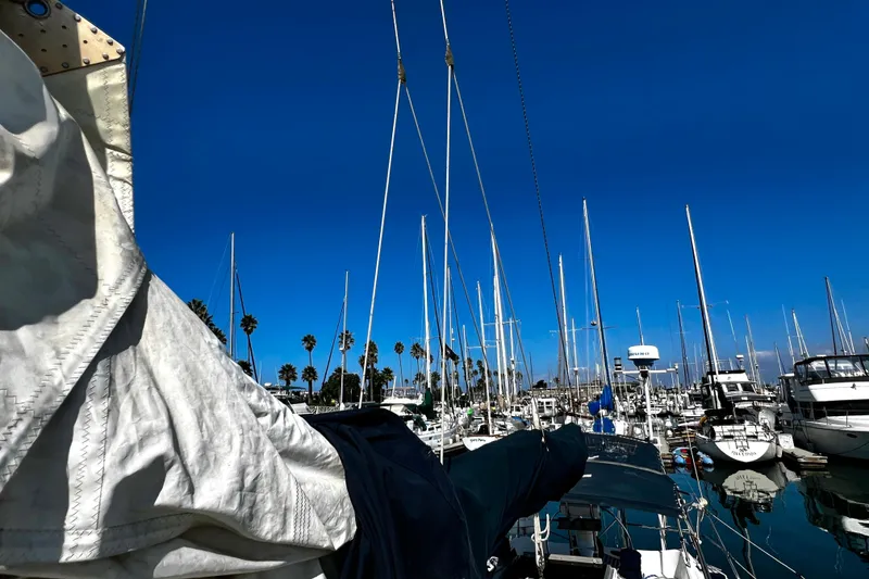 Slide: The Image of Sailboats docked at a marina under clear blue skies, featuring a 1989 Hunter Vision 32. - 22