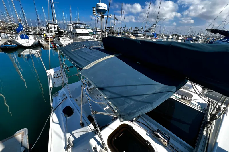 Slide: The Image of 1989 Hunter Vision 32 sailboat docked in a marina, surrounded by other boats. - 24