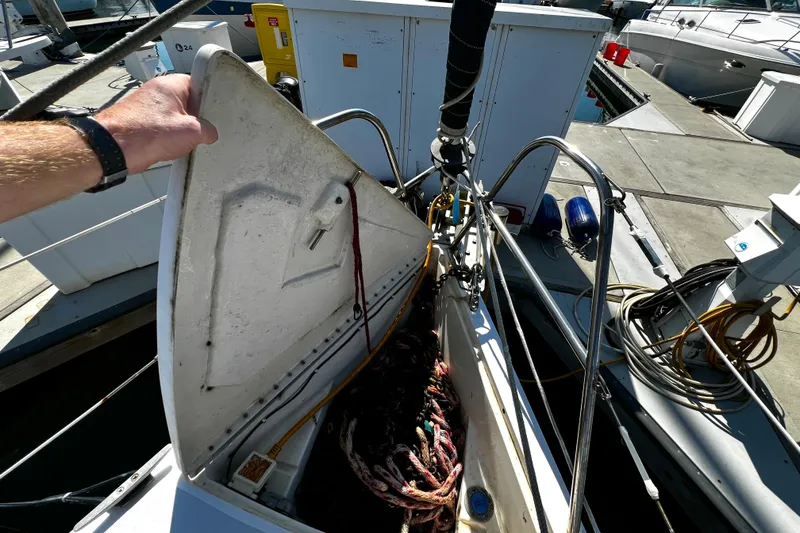 Slide: The Image of 1989 Hunter Vision 32 sailboat with open hatch, docked at marina. - 28