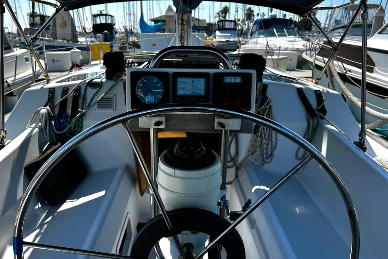 Slide: The Image of Cockpit of 1989 Hunter Vision 32 sailboat with steering wheel and navigation instruments. - 37