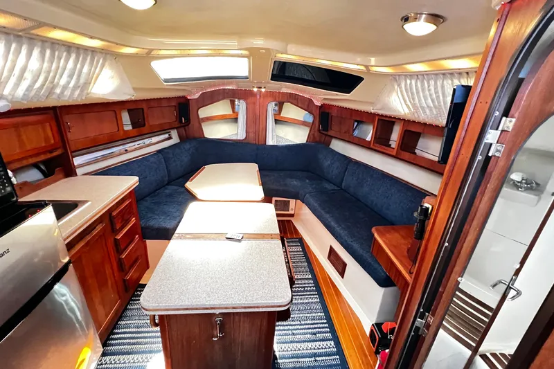Slide: The Image of Interior of 1989 Hunter Vision 32 sailboat with cozy seating and wooden cabinetry. - 40