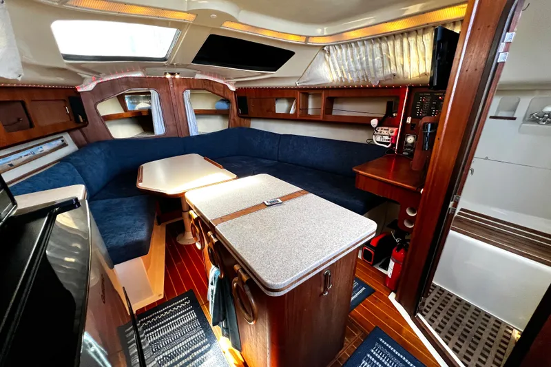 Slide: The Image of Interior of 1989 Hunter Vision 32 sailboat with cozy seating and wooden finishes. - 42