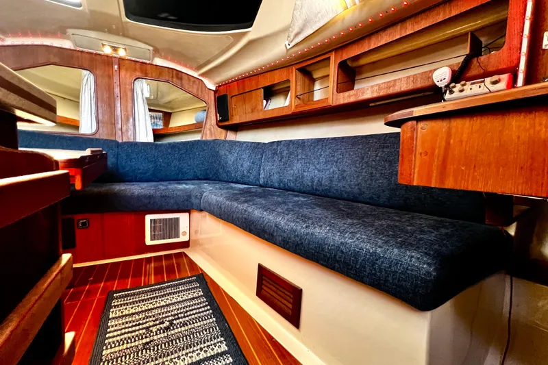 Slide: The Image of Interior of 1989 Hunter Vision 32 sailboat with blue seating and wooden accents. - 43