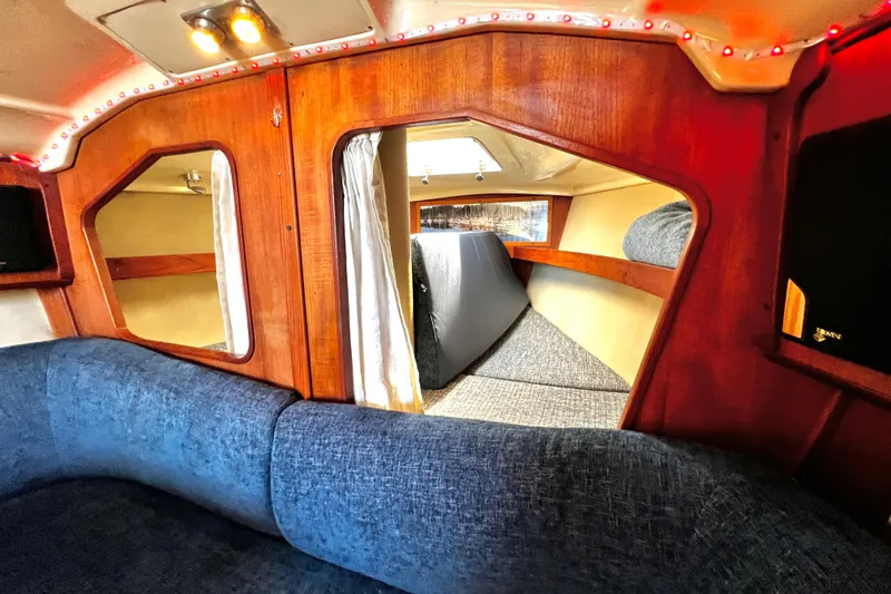 Slide: The Image of Interior of 1989 Hunter Vision 32 sailboat with cozy seating and wooden accents. - 45