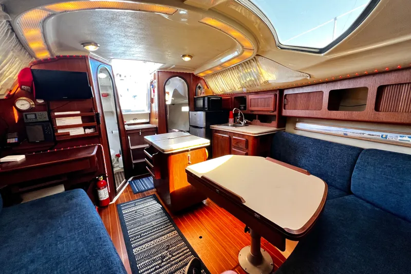 Slide: The Image of Interior of 1989 Hunter Vision 32 sailboat with cozy seating and wooden cabinetry. - 48