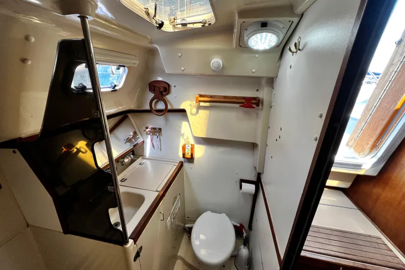 Slide: The Image of Interior of 1989 Hunter Vision 32 sailboat bathroom with sink, toilet, and window. - 50