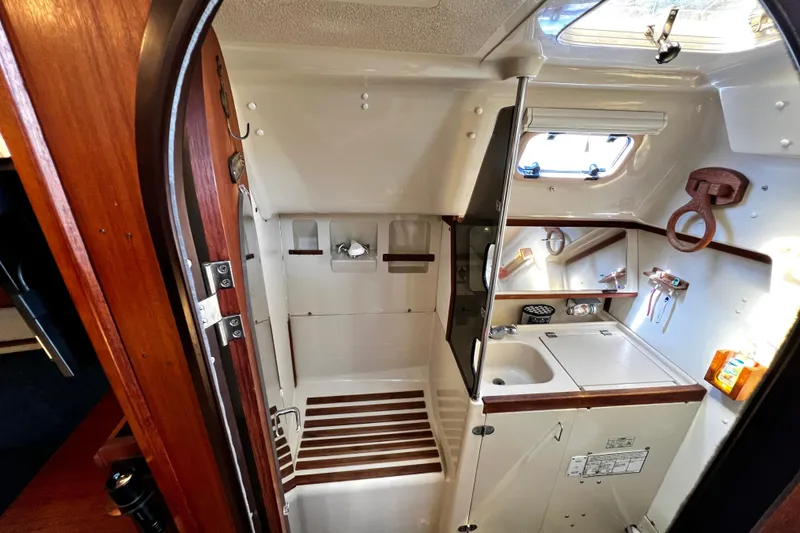 Slide: The Image of Interior of 1989 Hunter Vision 32 sailboat bathroom with sink, shower, and wooden accents. - 51