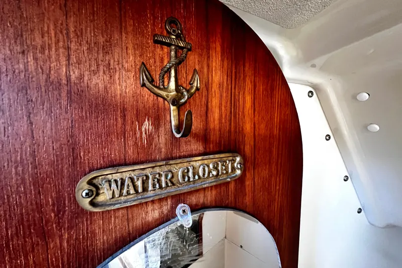 Slide: The Image of Wooden interior of 1989 Hunter Vision 32 sailboat with "Water Closet" sign and anchor hook. - 53