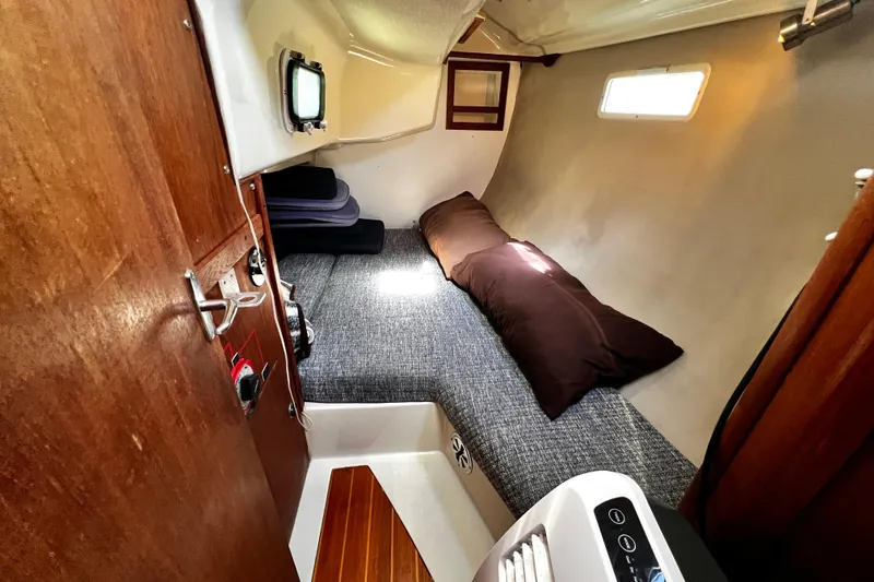 Slide: The Image of Cozy cabin interior of 1989 Hunter Vision 32 sailboat with bed and porthole. - 55