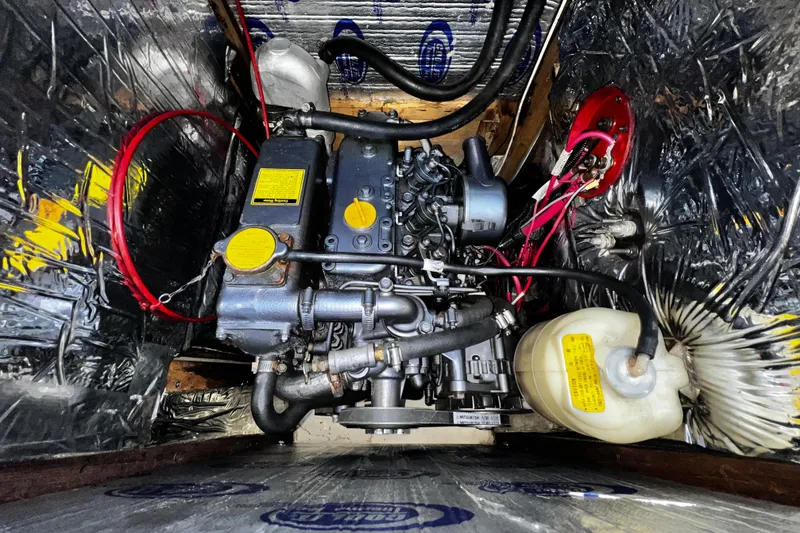 Slide: The Image of Engine compartment of a 1989 Hunter Vision 32 sailboat, featuring detailed mechanical components. - 58