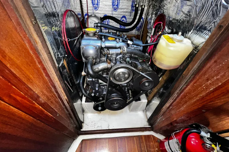 Slide: The Image of Engine compartment of 1989 Hunter Vision 32 sailboat with visible components and fire extinguisher. - 59