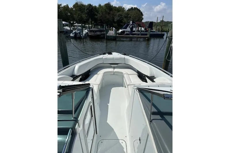 Slide: The Image of 2015 Formula 310 Bowrider boat with spacious seating, docked in a marina. - 11