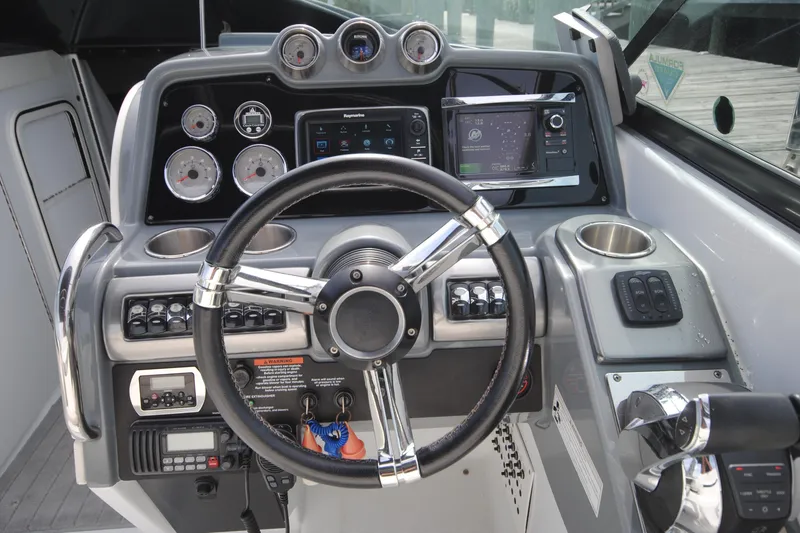 Slide: The Image of Dashboard of a 2015 Formula 310 Bowrider boat with steering wheel and controls. - 13