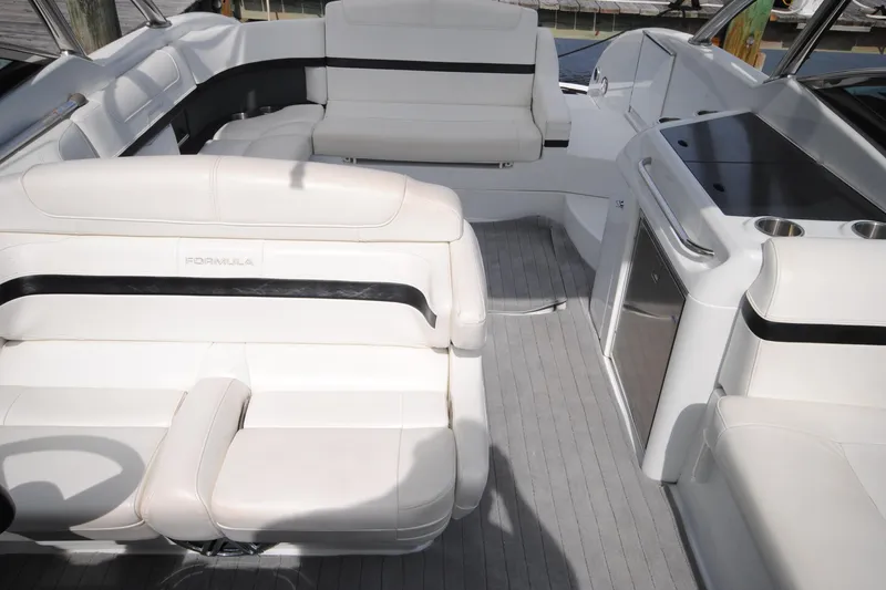 Slide: The Image of 2015 Formula 310 Bowrider interior with white seating and sleek design. - 14