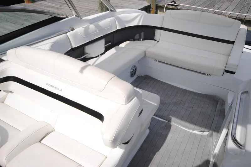 Slide: The Image of 2015 Formula 310 Bowrider interior with white seating and sleek design. - 15