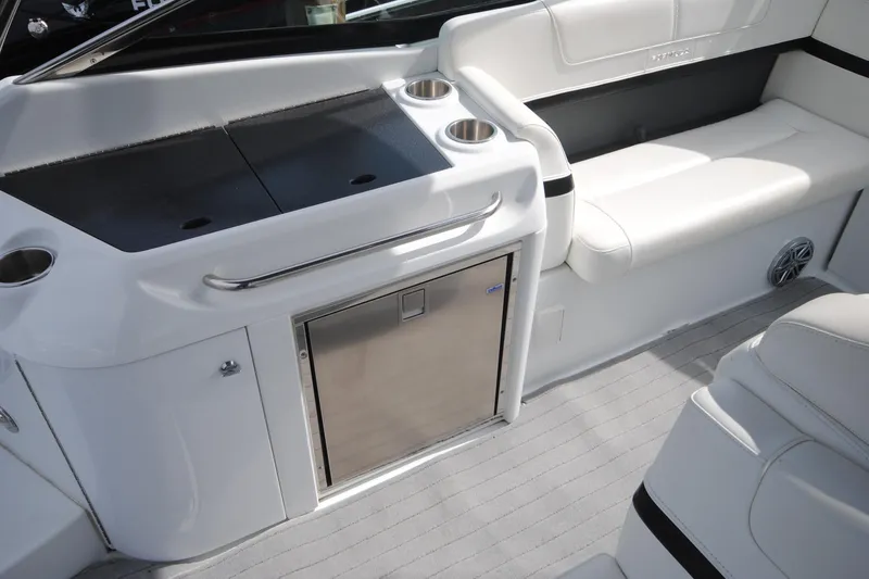 Slide: The Image of 2015 Formula 310 Bowrider interior with seating, cup holders, and stainless steel fridge. - 17
