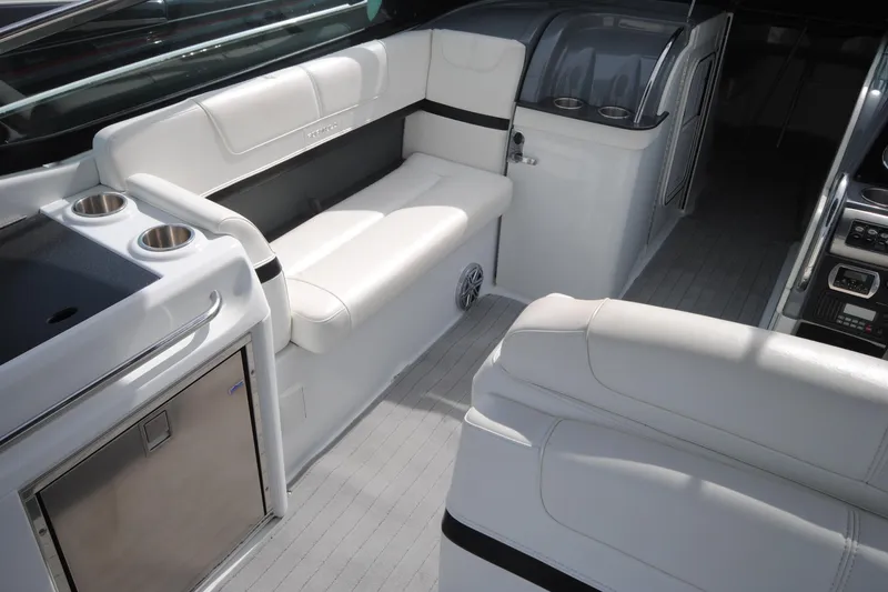 Slide: The Image of 2015 Formula 310 Bowrider interior with white seating and modern amenities. - 18