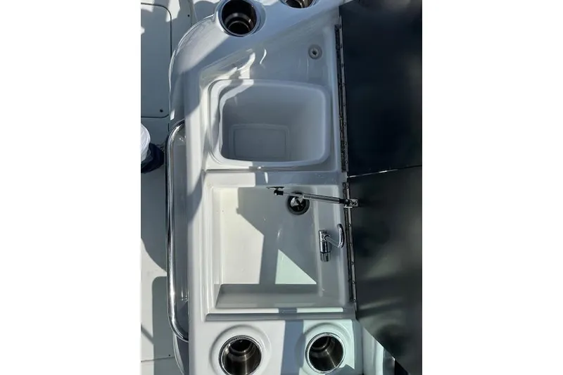 Slide: The Image of 2015 Formula 310 Bowrider boat sink and cup holders in cockpit area. - 19