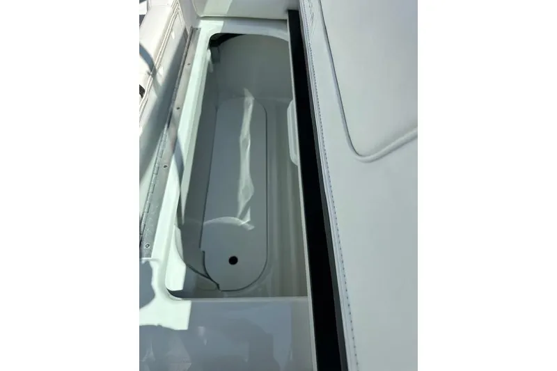 Slide: The Image of Storage compartment in 2015 Formula 310 Bowrider boat, featuring sleek white interior design. - 20