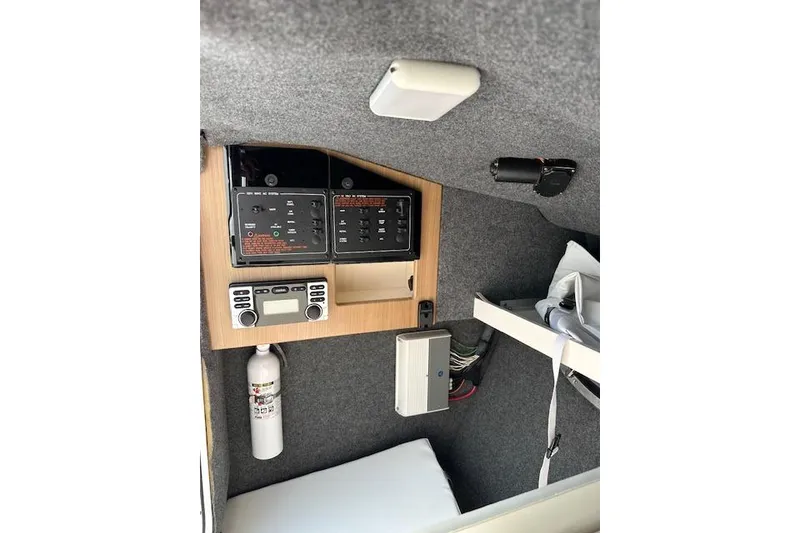 Slide: The Image of 2015 Formula 310 Bowrider cabin interior with control panels and safety equipment. - 21