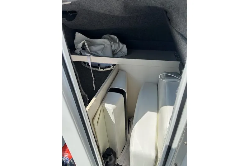 Slide: The Image of Interior storage area of a 2015 Formula 310 Bowrider boat with cushions and gear. - 24