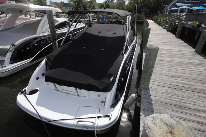 Slide: The Image of 2015 Formula 310 Bowrider docked, covered with black canvas, alongside wooden pier. - 3