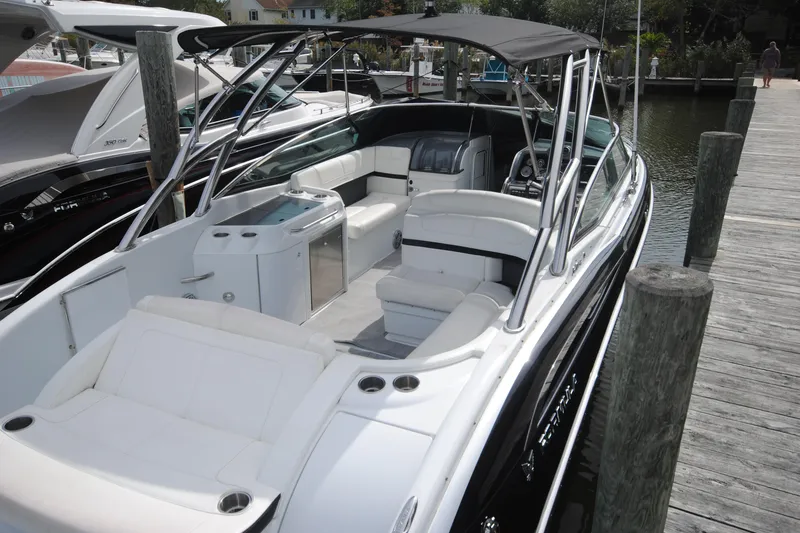 Slide: The Image of 2015 Formula 310 Bowrider boat docked, featuring spacious seating and sleek design. - 4